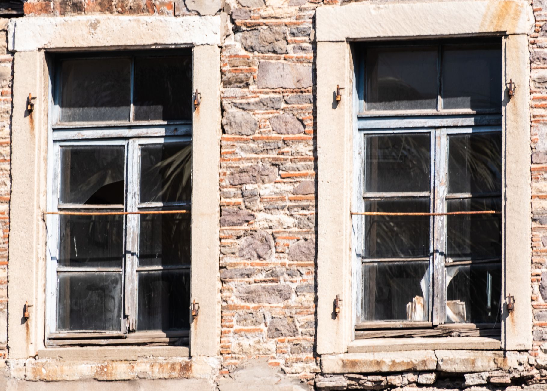 Close-up of vintage wooden windows on an old stone building facade in İzmir, Türkiye
